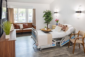 A private room with soft seating at the San Joaquin Nursing and Rehab facility